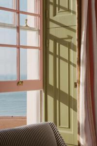 a room with a window with a view of the beach at Drakes Hotel in Brighton & Hove
