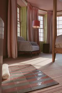 a living room with a couch and windows at Drakes Hotel in Brighton & Hove