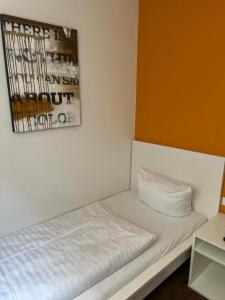 a bed in a room with a picture on the wall at Hostel S16 in Munich