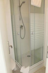 a bathroom with a glass shower with a toilet at Hostel S16 in Munich
