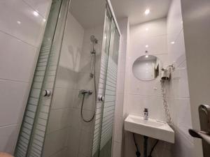 a bathroom with a shower and a sink at Hostel S16 in Munich