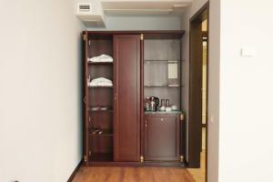 a room with a wooden pantry with shelves at Reikartz Astana in Astana