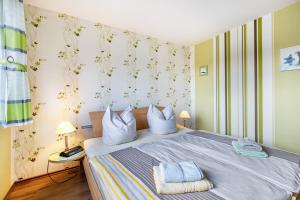 a bedroom with a bed with two pillows on it at Haus Dreeßen in Buchholz