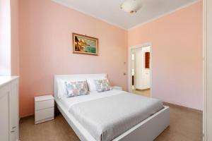 a bedroom with a large white bed in a room at Rose Sorrento House in Sorrento