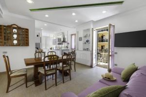 a living room with a purple couch and a table at Rose Sorrento House in Sorrento