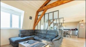 a living room with a couch and a table at Le Puy De Dome in Montaigut-le-Blanc