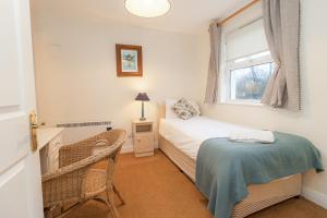a small bedroom with a bed and a window at Aughrim Holiday Village No 14 by Trident Holiday Homes in Aughrim