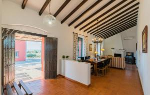 a living room with a table and a dining room at Cortijo Mazuecos by SharingCo in Lora del Río