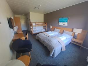 A bed or beds in a room at Møn Golf Resort - Hotel Præstekilde