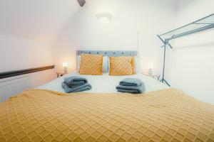 a bedroom with a bed with blue towels on it at Hidden Gem in Plymouth