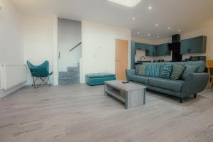a living room with a couch and a table at Hidden Gem in Plymouth