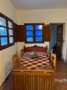 a room with a table with a rug on it at Casa Aziza , le charme andalou in Lanjarón