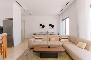 a living room with a couch and a table at Akamas Luxury Villas in Paphos City