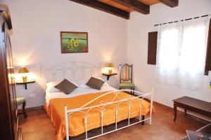 A bed or beds in a room at Locanda Rurale Santa Marta