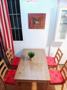 a wooden table with two chairs and a potted plant at Vacansis Chalet 3 Vedat in Torrent +7 photos