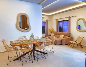 a living room with a table and chairs and a couch at Villa soléa - Route Ouarzazate in Marrakesh