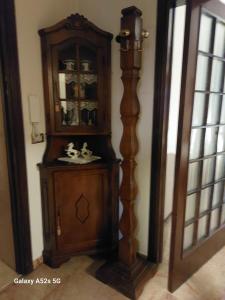 a wooden cabinet in the corner of a room at # Punto FM 9 # in Marghera +16 photos
