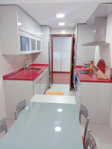 a kitchen with a red counter top and a sink at Turismo rural, San Sebastián,playa, parking privado in Azpeitia +13 photos