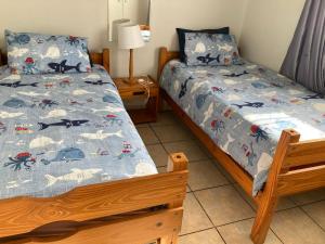 a bedroom with two twin beds and a lamp at Ankers in Margate