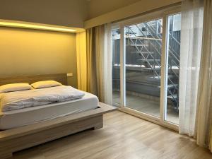 a bedroom with a bed and a large window at Avalon Stays in Guwahati