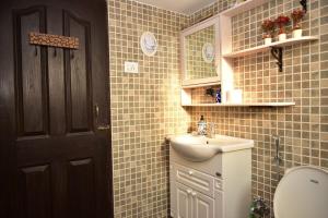a bathroom with a sink and a toilet and a mirror at Casa Terrazzo,2bhk apartment in Sucorro-Porvorim in Pilerne +13 photos
