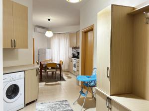 a kitchen and dining room with a washer and dryer at Maren apartment in Orikum