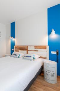 a bedroom with two beds and a trash can at Cit'Hotel Imperial in Sète