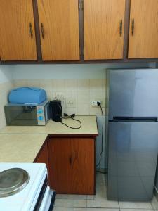 a kitchen with a refrigerator and a microwave at Ankers in Margate