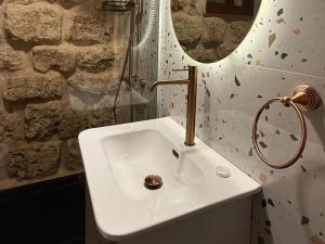 a bathroom with a white sink and a mirror at Villa Rosa Luxury Boutique Hotel in Batroûn