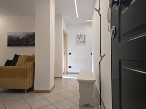 a living room with a couch and a refrigerator at Dolomiten Lounge - moderno con parcheggio privato in Pergine Valsugana