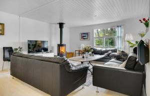a living room with two couches and a table at Pool activity house for 14 people in Marielyst