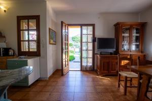 a kitchen with a door open to a living room at Belocations - House 50 meters from the sea in Solanas