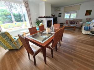 a living room with a wooden table and chairs at Villa Serena - Casa rural en Arcos con piscina, barbacoa, chimenea in Arcos de la Frontera