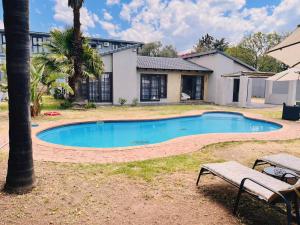 a swimming pool in the yard of a house at Three Bedroom Pool Villa in Sandton