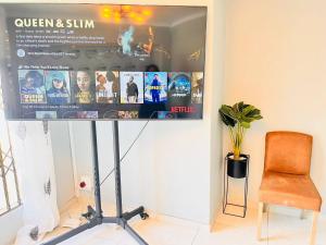 a room with a tv and a chair and a screen at Three Bedroom Pool Villa in Sandton
