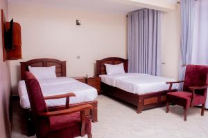 Ένα ή περισσότερα κρεβάτια σε δωμάτιο στο Tezor Hotel Entebbe