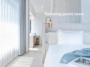 Postel nebo postele na pokoji v ubytování Mitsui Garden Hotel Yokohama Minatomirai Premier