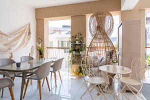 a dining room with two tables and chairs at Infinity - One-Bedroom Apt W Terrace in Larnaca in Larnaca