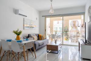 a living room with a couch and a table at Infinity - One-Bedroom Apt W Terrace in Larnaca in Larnaca