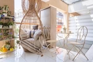 a person sitting in a chair in a room at Infinity - One-Bedroom Apt W Terrace in Larnaca in Larnaca