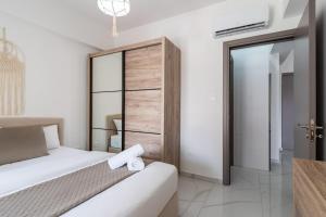 a hotel room with a bed and a closet at Infinity - One-Bedroom Apt W Terrace in Larnaca in Larnaca +8 photos