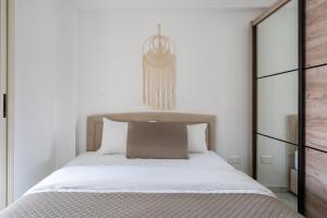 a bedroom with a large bed with white sheets at Infinity - One-Bedroom Apt W Terrace in Larnaca in Larnaca