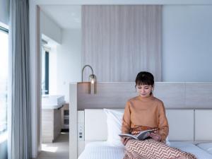 Postel nebo postele na pokoji v ubytování Mitsui Garden Hotel Yokohama Minatomirai Premier