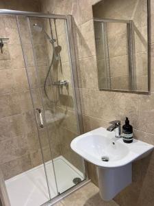 a bathroom with a sink and a shower at The Castle B&B in Inverness +25 photos