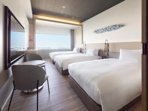 Postel nebo postele na pokoji v ubytování Mitsui Garden Hotel Yokohama Minatomirai Premier