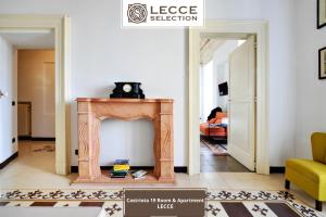 a fireplace in a living room with a dog on top at Castriota 19 Room & Apartment - Lecce Selection in Lecce
