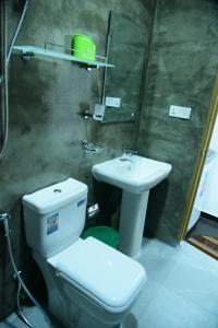 a bathroom with a toilet and a sink at Captains Cabin Hikkaduwa in Hikkaduwa +10 photos