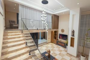 a staircase in a house with a living room at Parliament Palace Hotel in Khujand