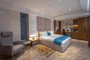 a bedroom with a bed and a desk and a chair at Parliament Palace Hotel in Khujand