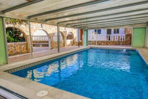 a large swimming pool in a building at Cosy 1 bed pool house in Albir